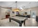 Open game room includes a billiards table, island seating, and skylights for bright, recreational space at 4711 Placid Cir, Sarasota, FL 34231