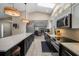 Bright kitchen boasts stainless appliances, counter seating, and seamless flow to the living room at 4711 Placid Cir, Sarasota, FL 34231