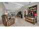 Comfortable living room with a stone fireplace, tile floors, and beverage center at 4711 Placid Cir, Sarasota, FL 34231