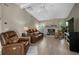 Inviting living room with tile floors, a stone fireplace, and comfortable leather seating at 4711 Placid Cir, Sarasota, FL 34231