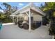 Elegant outdoor kitchen with bar seating and cozy lounge area, ideal for outdoor gatherings at 4711 Placid Cir, Sarasota, FL 34231