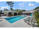 Sparkling pool, pool house, and lounge chairs for outdoor enjoyment and relaxation at 4711 Placid Cir, Sarasota, FL 34231