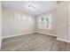 Living room featuring wood-look tile floors, white trim, and a modern light fixture at 4829 Antrim Dr, Sarasota, FL 34240