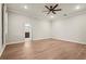 Serene bedroom with hardwood flooring, neutral paint, ceiling fan and a doorway to the bathroom at 5085 Ivory Stone Dr, Wimauma, FL 33598