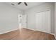 Bedroom with wood floors, closet, and bright neutral paint at 5085 Ivory Stone Dr, Wimauma, FL 33598
