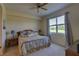 Cozy bedroom featuring a large window, ceiling fan, and comfortable furnishings at 5211 Mahogany Run # 113, Sarasota, FL 34241