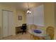 Bright breakfast nook with a glass table, chairs, and a built in desk perfect for a quick meal or home office at 5211 Mahogany Run # 113, Sarasota, FL 34241