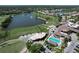 Aerial shot overlooking the golf course, lake, country club, and sparkling community pool at 5211 Mahogany Run # 113, Sarasota, FL 34241