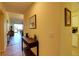 Inviting home entryway with light walls, tile floors, decor table with plants, and art-filled walls at 5211 Mahogany Run # 113, Sarasota, FL 34241