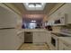Well-lit kitchen with stainless steel dishwasher and modern appliances at 5211 Mahogany Run # 113, Sarasota, FL 34241