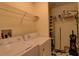 Spacious laundry room with washer, dryer, wire shelving and storage at 5211 Mahogany Run # 113, Sarasota, FL 34241