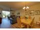 Open concept living space with combined dining and living room featuring hard wood floors and sliding glass door to Lanai at 5211 Mahogany Run # 113, Sarasota, FL 34241