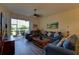 The cozy living room features hardwood floors, comfortable couches, a ceiling fan and a screened-in lanai at 5211 Mahogany Run # 113, Sarasota, FL 34241