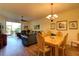 Open concept living space with combined dining and living room featuring hard wood floors and sliding glass door to Lanai at 5211 Mahogany Run # 113, Sarasota, FL 34241
