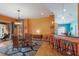 Open-concept dining area featuring stylish furnishings, a unique light fixture, and a seamless transition to outdoor patio at 5227 Lansdowne Way, Palmetto, FL 34221
