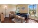 Comfortable living room with hardwood floors, leather furniture, and large windows offering scenic views at 5227 Lansdowne Way, Palmetto, FL 34221