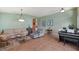 Comfortable living room with neutral-toned sofas, tile floors, pendant lighting, and stylish accents at 5227 Lansdowne Way, Palmetto, FL 34221