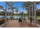 Relaxing screened patio overlooking a peaceful pond with lush landscaping and seating area at 5227 Lansdowne Way, Palmetto, FL 34221