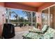 Outdoor patio area overlooking lake with lounge seating, outdoor seating and a grill at 5227 Lansdowne Way, Palmetto, FL 34221