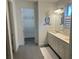 Bright bathroom featuring double sinks, a full vanity, a decorative mirror, and ample lighting at 5262 Asher Ct, Sarasota, FL 34232