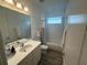 Clean bathroom featuring a modern vanity, framed mirror, and shower-tub combo with curtain at 5262 Asher Ct, Sarasota, FL 34232
