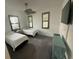 Relaxing bedroom with two twin beds, ceiling fan, and large windows with blinds at 5262 Asher Ct, Sarasota, FL 34232