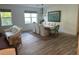 Dining room with a large table, chairs, a decorative chandelier, and natural light from the windows at 5262 Asher Ct, Sarasota, FL 34232