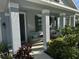 Inviting front porch featuring neutral furniture, a sitting area, and a columned facade at 5262 Asher Ct, Sarasota, FL 34232