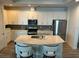 Modern kitchen with white cabinetry, stainless steel appliances, and a center island with seating at 5262 Asher Ct, Sarasota, FL 34232