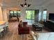 Open-concept living room with stylish furnishings, and sliding glass doors leading to the outdoors at 5262 Asher Ct, Sarasota, FL 34232