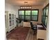 Home office with a large window, a desk, and built-in bookshelves, offering a functional workspace at 5262 Asher Ct, Sarasota, FL 34232