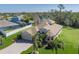 Overhead view of a beautifully landscaped single-Gathering house with a long brick driveway, 3 car garage, and serene water view at 5412 72Nd E Ter, Ellenton, FL 34222