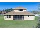 Back exterior view of this two-story home with a screened-in lanai and lush green lawn at 5412 72Nd E Ter, Ellenton, FL 34222