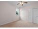 Neutral bedroom featuring plush carpeting, a ceiling fan, and double door closet at 5412 72Nd E Ter, Ellenton, FL 34222