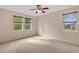 Carpeted bedroom with three windows, natural light, and ceiling fan at 5412 72Nd E Ter, Ellenton, FL 34222