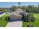Stunning single-Gathering home featuring a large 3 car garage, brick driveway, lush landscaping, and tranquil waterfront views at 5412 72Nd E Ter, Ellenton, FL 34222