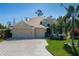 Exterior of a house featuring a three-car garage and well-maintained landscaping at 5412 72Nd E Ter, Ellenton, FL 34222