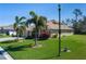 Lawn with palm trees in front of a house and a street light at 5412 72Nd E Ter, Ellenton, FL 34222