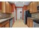 Spacious kitchen featuring stainless steel appliances, tile backsplash, and ample cabinet space at 5412 72Nd E Ter, Ellenton, FL 34222