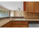 This kitchen includes a breakfast bar with granite countertops overlooking the cozy living room at 5412 72Nd E Ter, Ellenton, FL 34222