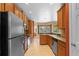 Well-lit kitchen features stainless steel appliances, wooden cabinets, and a large window overlooking the backyard at 5412 72Nd E Ter, Ellenton, FL 34222
