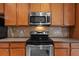 Kitchen showcasing stainless steel appliances and cabinetry with a tile backsplash at 5412 72Nd E Ter, Ellenton, FL 34222