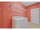 Laundry room with washer, dryer, and wall-mounted shelving offers convenience at 5412 72Nd E Ter, Ellenton, FL 34222