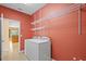 Laundry room with washer, dryer, and wall-mounted shelving offers convenience at 5412 72Nd E Ter, Ellenton, FL 34222