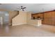 An open concept living room with tiled floors, a staircase, and a kitchen area at 5412 72Nd E Ter, Ellenton, FL 34222