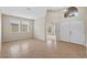 Bright living room features neutral paint, tile floors, and double front doors for inviting home at 5412 72Nd E Ter, Ellenton, FL 34222