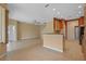Open living space featuring tile floors, ceiling fan, and a breakfast bar connecting the kitchen at 5412 72Nd E Ter, Ellenton, FL 34222