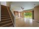 A spacious living room with stairs, tiled floors, and a view of the backyard through sliding glass doors at 5412 72Nd E Ter, Ellenton, FL 34222
