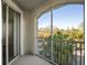 Enjoy scenic views from this screened balcony with white railings, overlooking lush greenery at 5450 Bentgrass Dr # 5-301, Sarasota, FL 34235