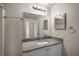 Well-lit bathroom with a granite countertop vanity and a large mirror at 5450 Bentgrass Dr # 5-301, Sarasota, FL 34235